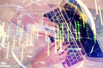 Double exposure of woman hands working on computer and financial theme hologram drawing. Top View. Business concept.