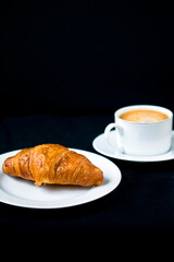 A fresh croissant with morning coffee