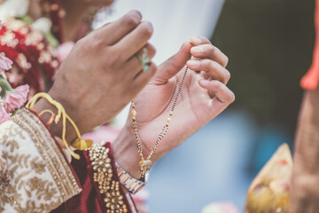 Indian Hindu wedding ceremony ritual items, hands and decorations close up