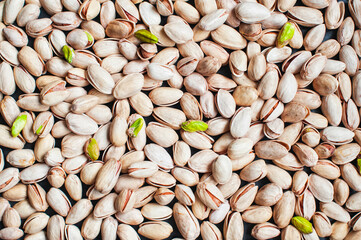 Pistachio texture. Nuts. Green fresh pistachios as texture. Roasted salted pistachio nuts healthy delicious food studio photo.