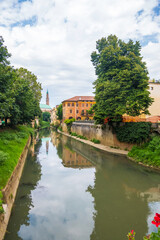 Fototapeta na wymiar View of Retrone river and the clock tower of Vicenza, Italy