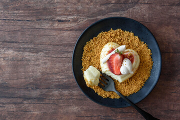 Single serving of heart shaped creamy Italian cheesecake on graham cracker crumbles
