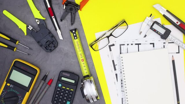 Architecture and building concept. Construction tools and plans appear. stop motion 