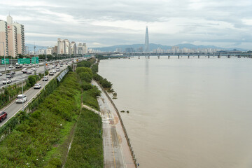 Naklejka premium Seoul, Korea - August 8,2020: The Han River is rising beside Gangbyeon Expressway and some trees are submerged.