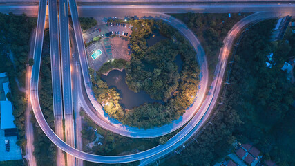Aerial view of higway road and movement vehicle in Chiang Mai city of Thailand at twilight.