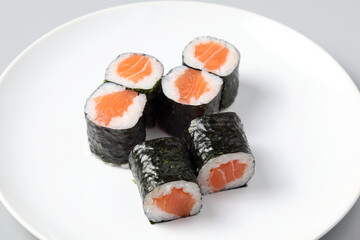 Salmon sushi maki roll isolated on white background © อนันตชัย พลเทพ