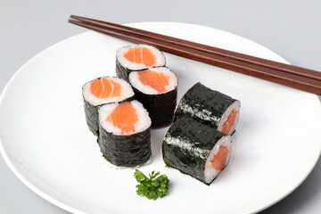 Salmon sushi maki roll isolated on white background