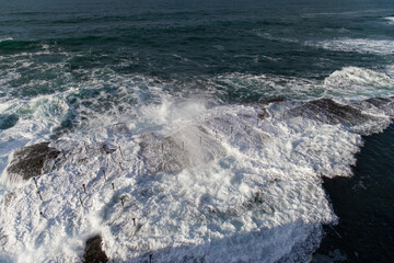 Rock pool covered by big swell.