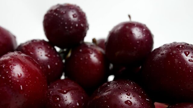 Sweet ripe plums with water drops, closeup