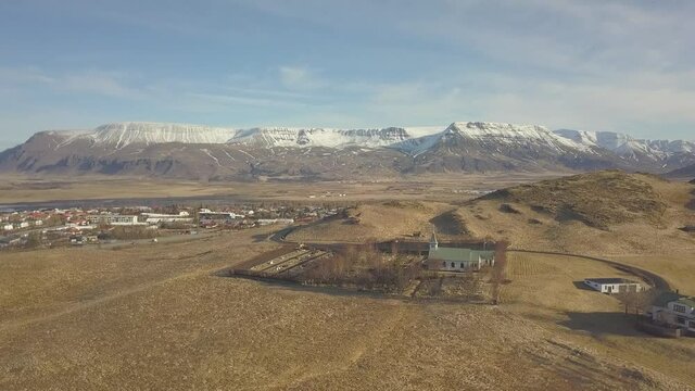 Aerial Fly Over Local Church And Mountain Range Near Reykjavik in Iceland