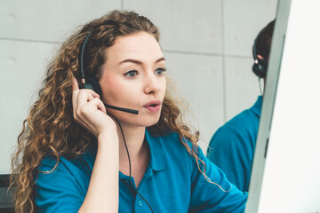 Business people wearing headset working in office to support remote customer or colleague. Call center, telemarketing, customer support agent provide service on telephone video conference call.