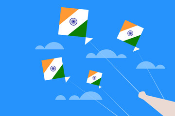 Hand holding Kites with Indian flag colours flying in the sky