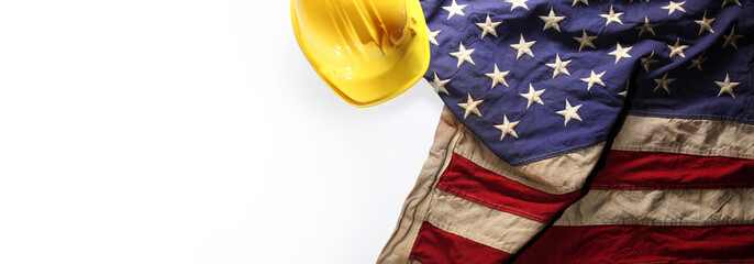 Hardhat on US American flag. Strong American workforce or industry, or America labor day concept....