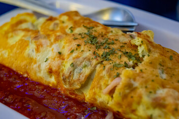 Close up shot of delicious Omelette with tomato sauce
