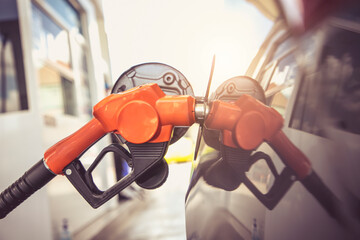 Close up of fuel monitoring system refueling a petroleum to vehicle at gas station.