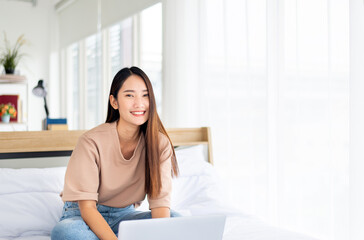 Asian woman working on laptop at home,Happy and smiling,Working from home