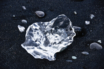 Glacial ice washed up on black sand beach at mouth of Jokulsa River, Jokulsarlon, southern Iceland