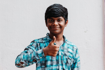 Portrait of an Indian kid giving thumbs up	