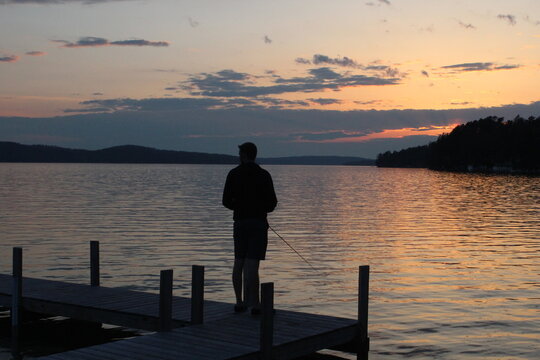 silhouette of a man fishing