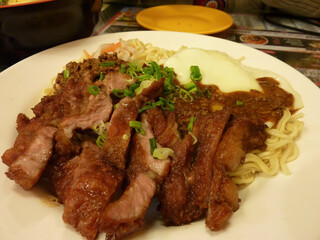 Close up shot of delicious fried pork chop with instant noodles