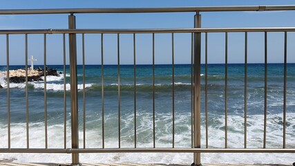 empty sandy beach with turquoise waving ocean water from above during covid 19 epidemic and quarantine. crisis and decline in the tourism sector, disastrous season 2020