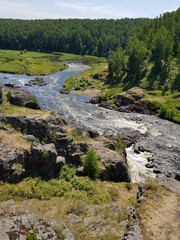 Fototapeta na wymiar Large stones lie in a mountain river