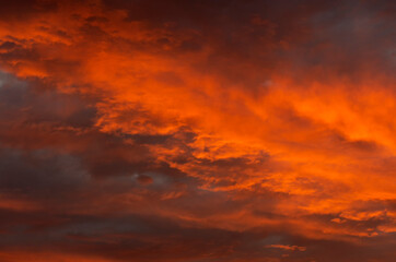 Cloudy landscape at sunset with a beautiful orange sky