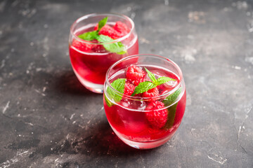 Raspberry and mint cocktail in glass on the rustic background. Selective focus. Shallow depth of field.