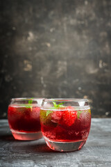 Raspberry and mint cocktail in glass on the rustic background. Selective focus. Shallow depth of field.