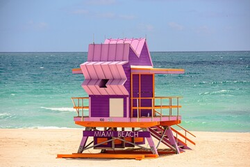 Miami Beach with lifeguard tower and coastline with colorful cloud and blue sky. World famous...