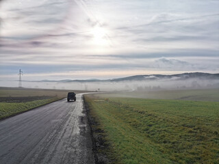 Car riding through the fog, Bieszczady, Poland