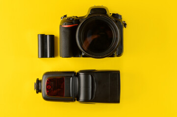 Photographer's equipment.Flat lay composition with photographer's equipment and accessories on yellow background