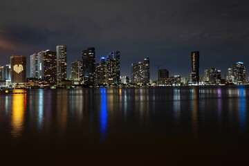 Miami night. Miami Florida, sunset panorama with colorful illuminated business and residential buildings and bridge on Biscayne Bay.