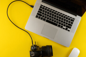 Photographer's equipment.Flat lay composition with photographer's equipment and laptop on yellow...