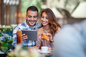 Couple have fun together in cafe.