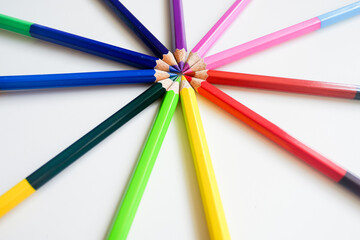 The cropped shot view of color pencils with white background, blank copy space screen for your text message or information content.