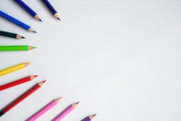 Fototapeta premium The cropped shot view of color pencils with white background, blank copy space screen for your text message or information content.