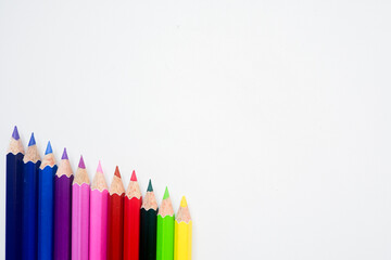 The cropped shot view of color pencils with white background, blank copy space screen for your text message or information content.