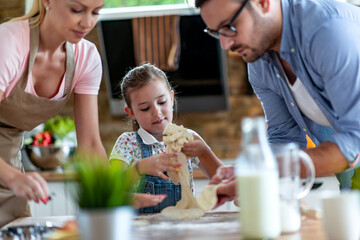 Family makes a cookie in the kitchen