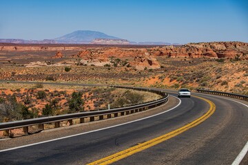 Asphalt road in USA. Barren scenery. Desert highway of the American southwest. Endless straight. Route 66, Arizona California.