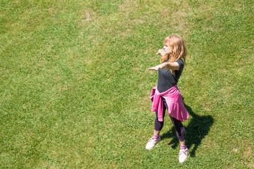 woman doing sport exercises on the city grass