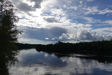 River in Sweden with reflection of the clouds in the water
