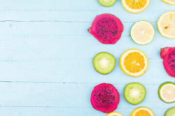 Fruit background. Colorful fresh fruit on Blue wooden board. Orange, Dragon fruit,  lemon，Flat lay, top view,