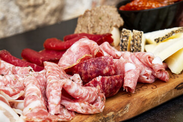 Rustic Tuscan tray with typical products: prosciutto (ham), brawn, finocchiona, crostini, salami,...