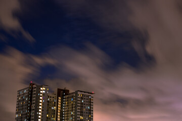 Fototapeta premium The high angle background of the city view with the secret light of the evening, blurring of night lights, showing the distribution of condominiums, dense homes in the capital community