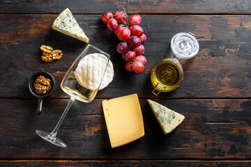 Fresh grapes , sauvignon wine, french cheeses, honey and nuts over rustic weathered wood. Top view with copy space.