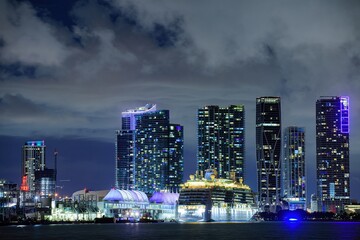 Miami. Cruise ship in the Port of Miami at sunset with multiple luxury yachts.