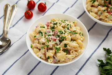 Homemade Macaroni Salad in white bowls, side view.