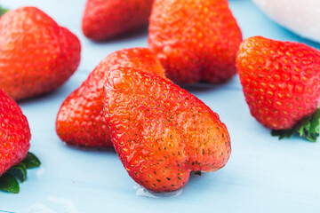 Bunch of fresh strawberries on wooden board background
