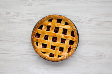 Yummy Homemade Cherry Pie on a white wooden background, top view. Flat lay, overhead, from above.
